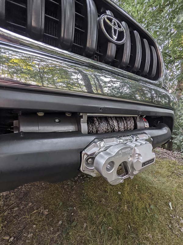 completed hidden winch installation on first gen tacoma overland truck build with Warn M8000 winch and Factor 55 Ultrahook