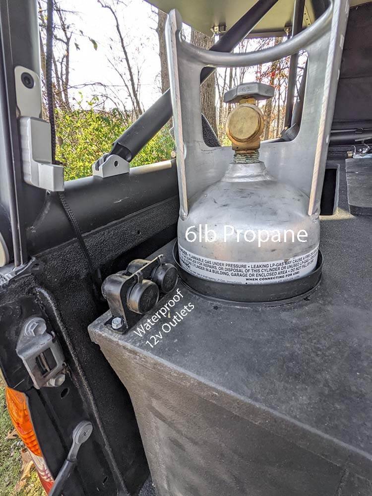 propane tank storage and 12v electrical installed in tacoma truck camping setup