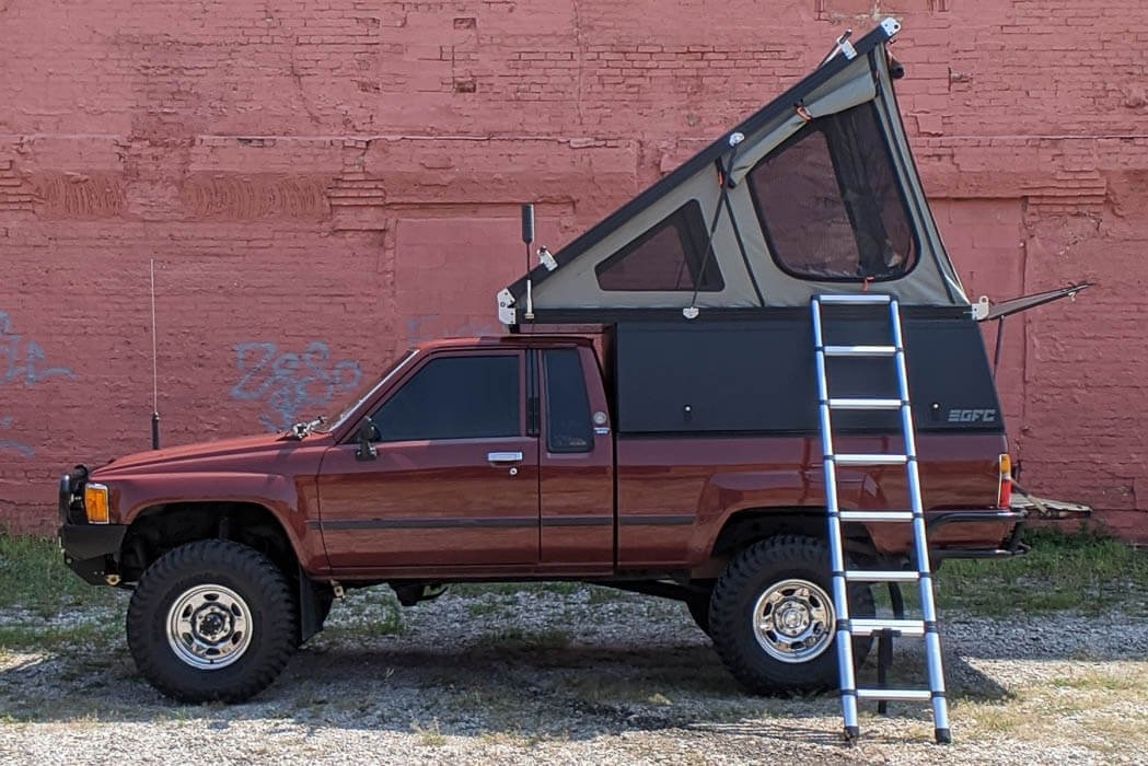 toyota pickup with V1 Go Fast Camper installed and camper fully open 