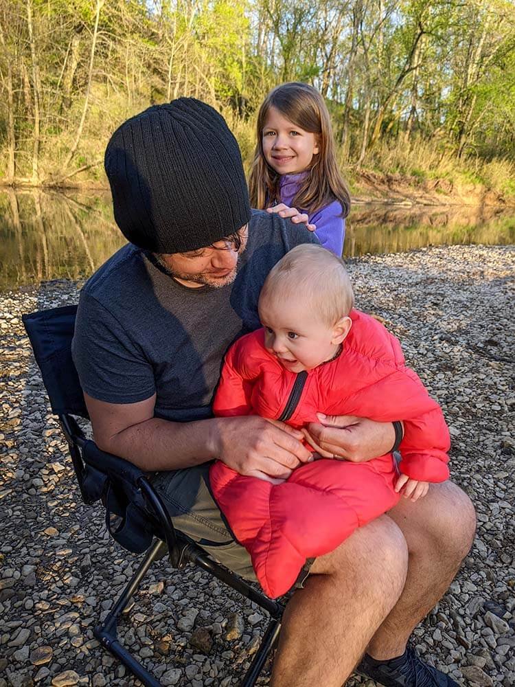 happy baby in camping sleeping bag at camp