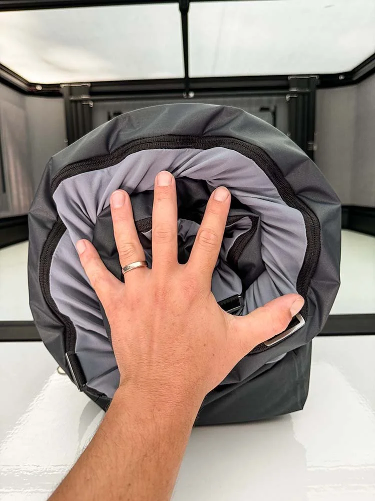 demonstrating the packed size of the stored memory foam camping bed