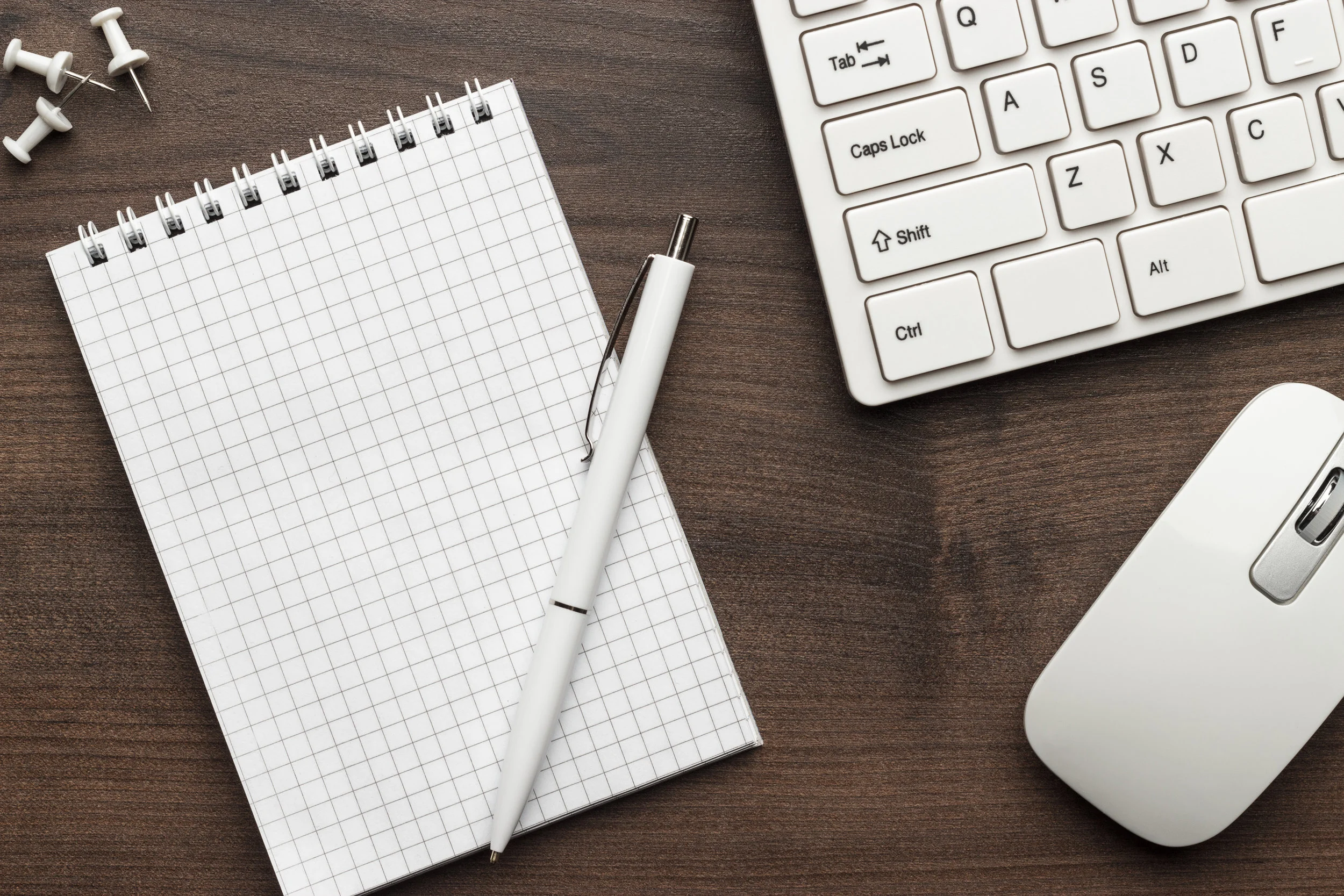 office-table-with-notepad-and-computer-PUCDLBQ.jpg
