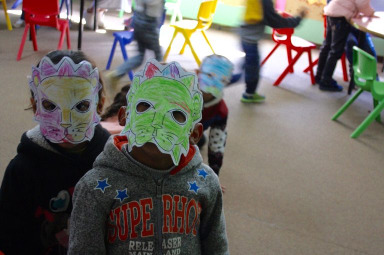 Two Core Early Childhood students pose in their lion masks.