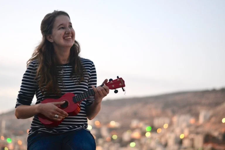 International Intern Katherine practices the ukulele.