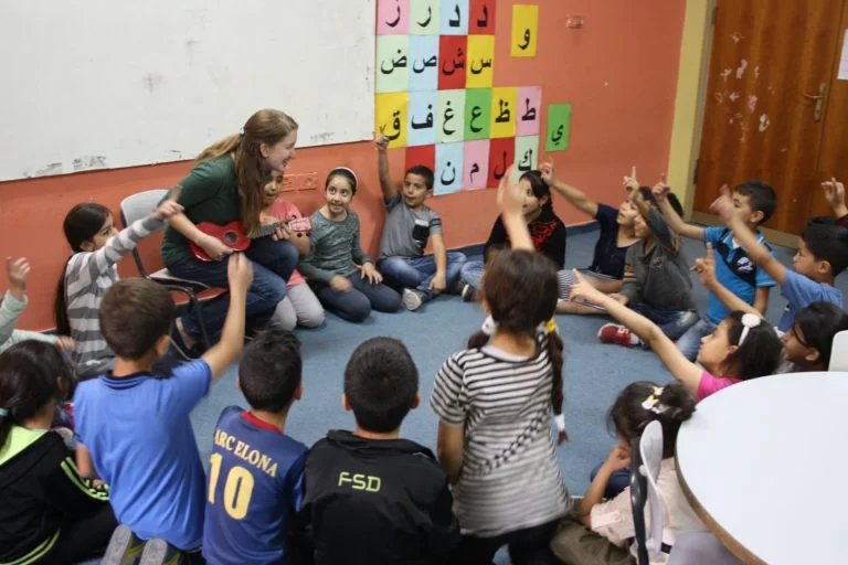 International Intern Katherine sings with her Core Early Childhood education class.