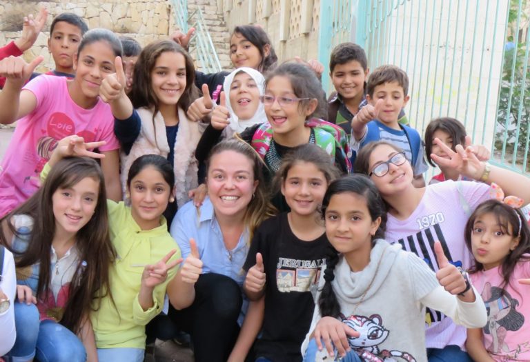 International Intern Sally and TYO students smile for a photo after classes wrap up for the day.