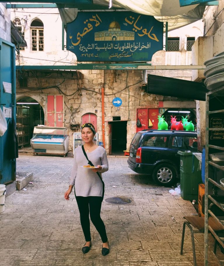 EFL Fellow Catalina enjoys knafeh at a shop in the Old City.
