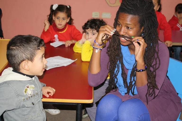 EFL Fellow Mecca plays with the children of a Core AM class before the lesson begins.