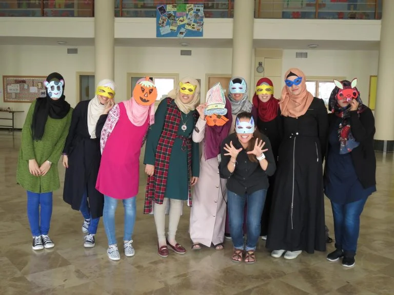 EFL Fellow Leah and her class show off their masks created during an EFL class.