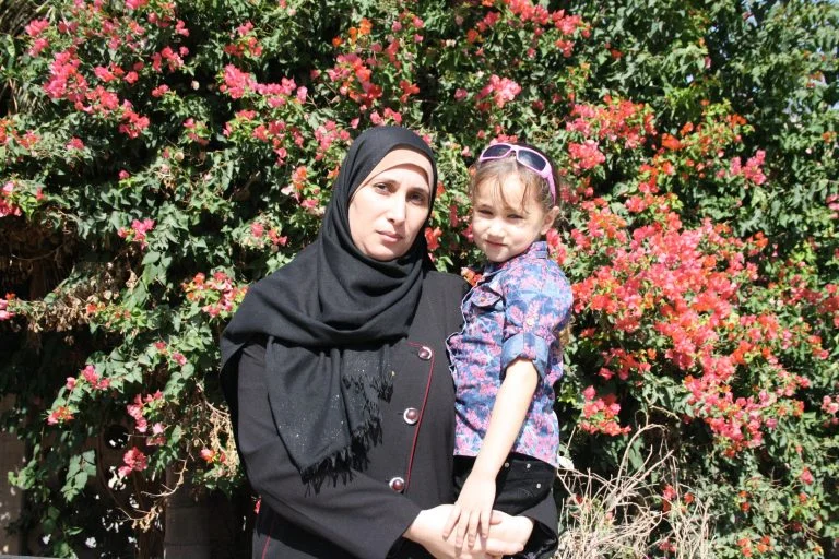 The Women’s Group participant Wafa and her daughter, Core student Aya both enjoy their time in the sunshine after their classes at TYO.
