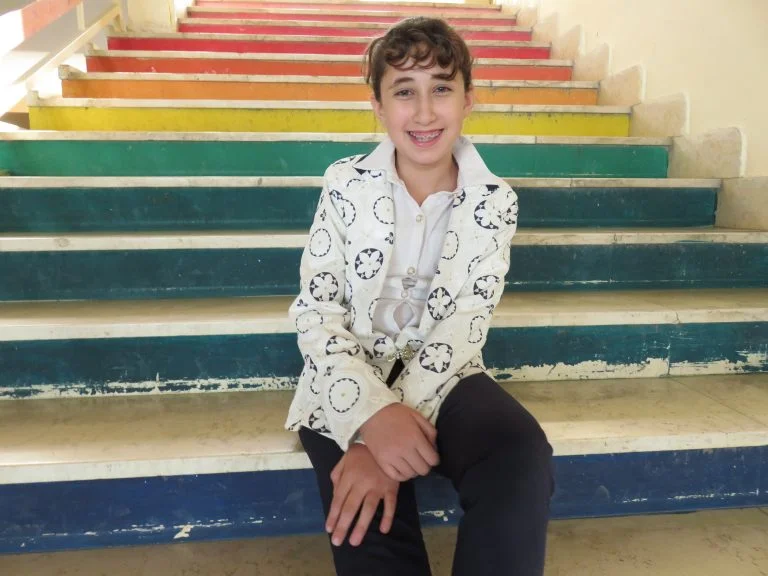 Student Reem smiles before her class with the Academic Support Program.
