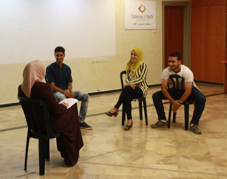 EFL students participate in a skit using humor to practice their English skills.