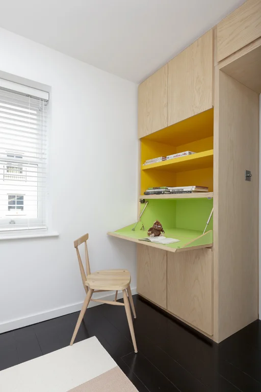 natural wood bespoke hidden office desk with yellow green accents