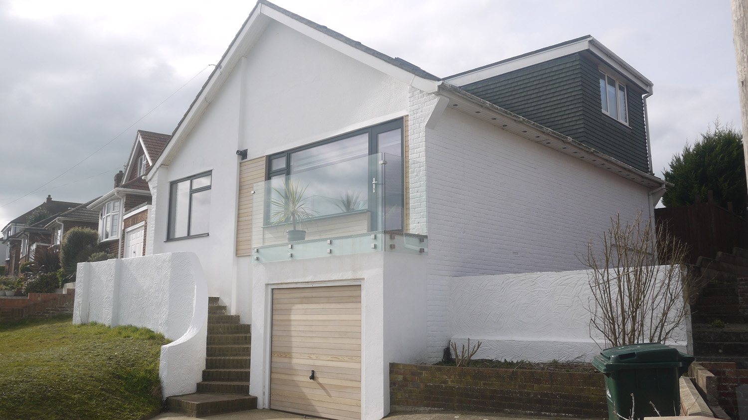 white rendered home with glass balustrade