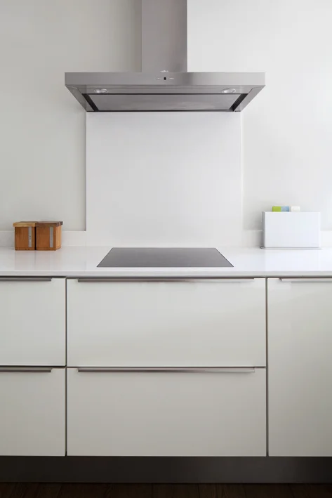contemporary white bespoke kitchen with discreet pull handles