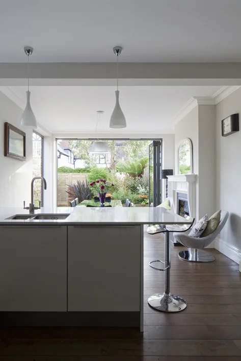 open plan kitchen diner to colourful landscaped garden