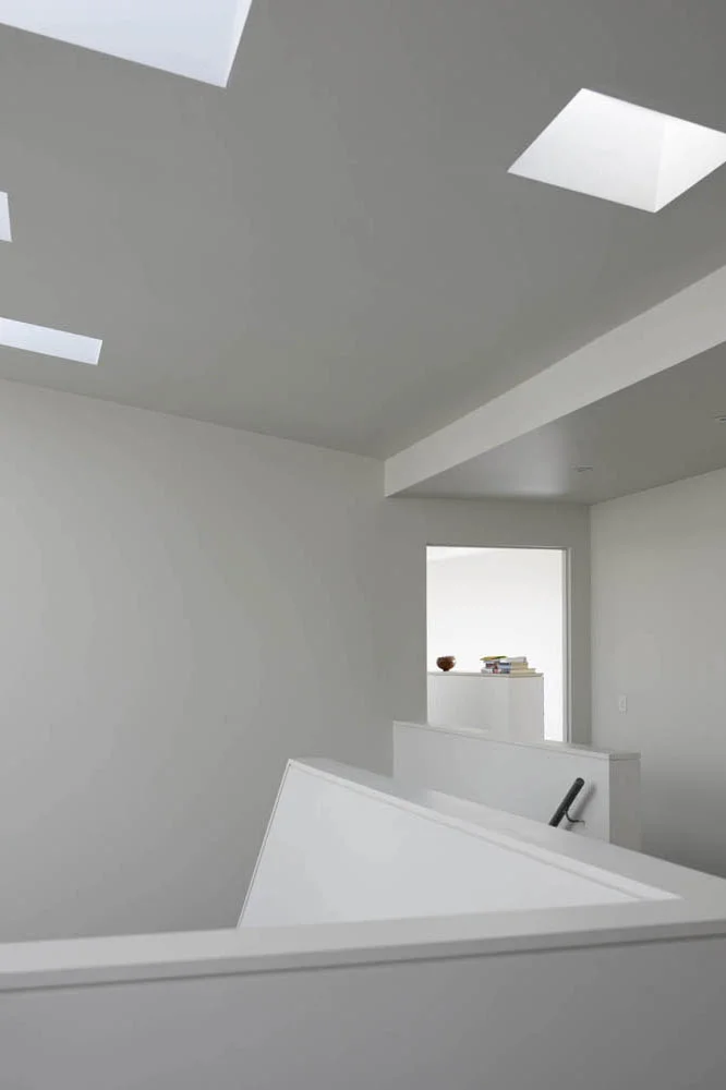 sculptural stair gallery area with interesting skylights