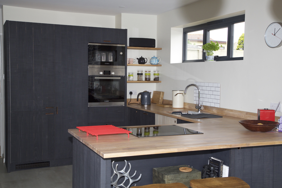 bespoke kitchen with dark cabinets and wood countertops