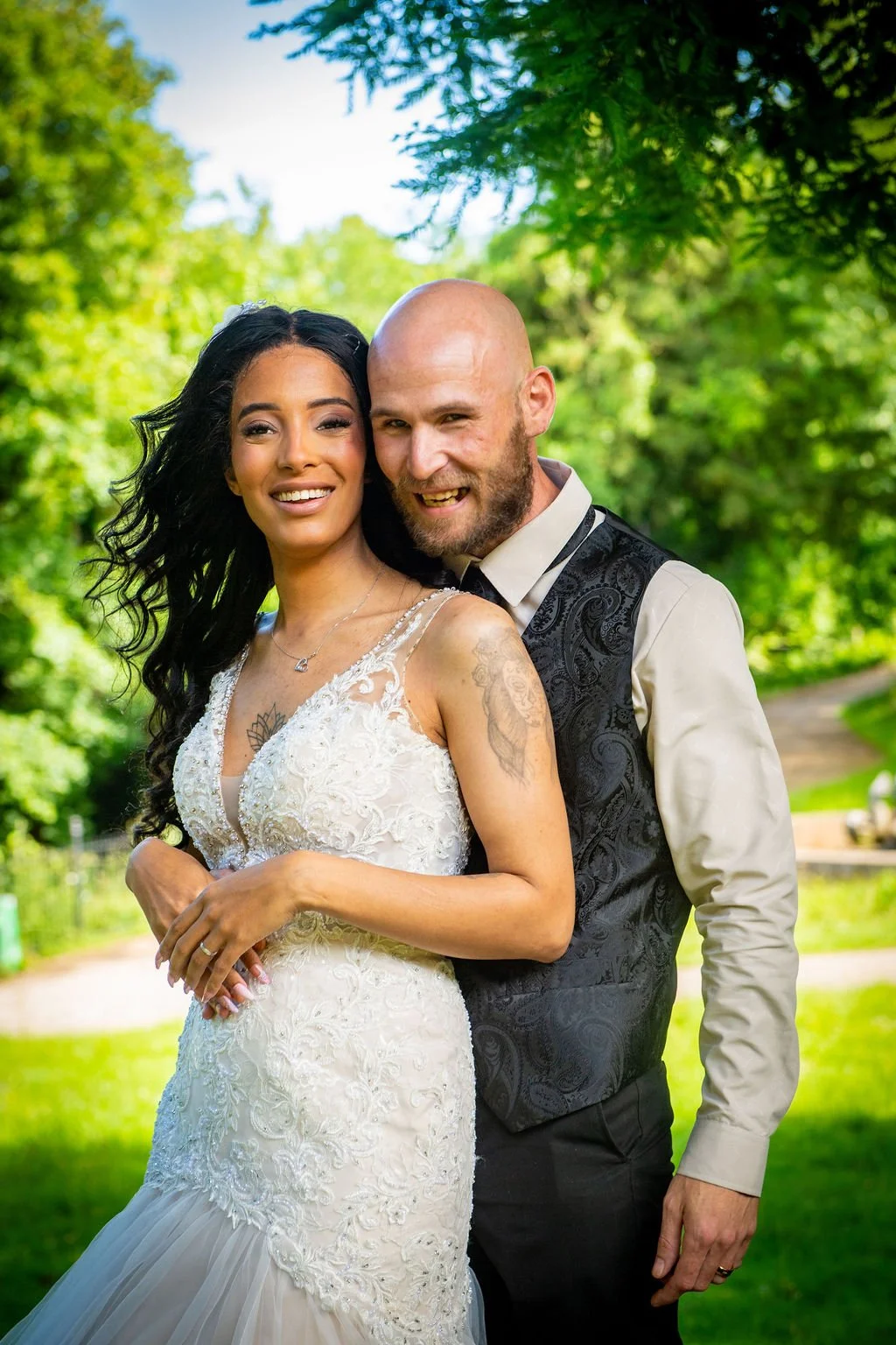 relaxed outdoor wedding portrait of a bride and groom in a sunny South Wales Pontypool park