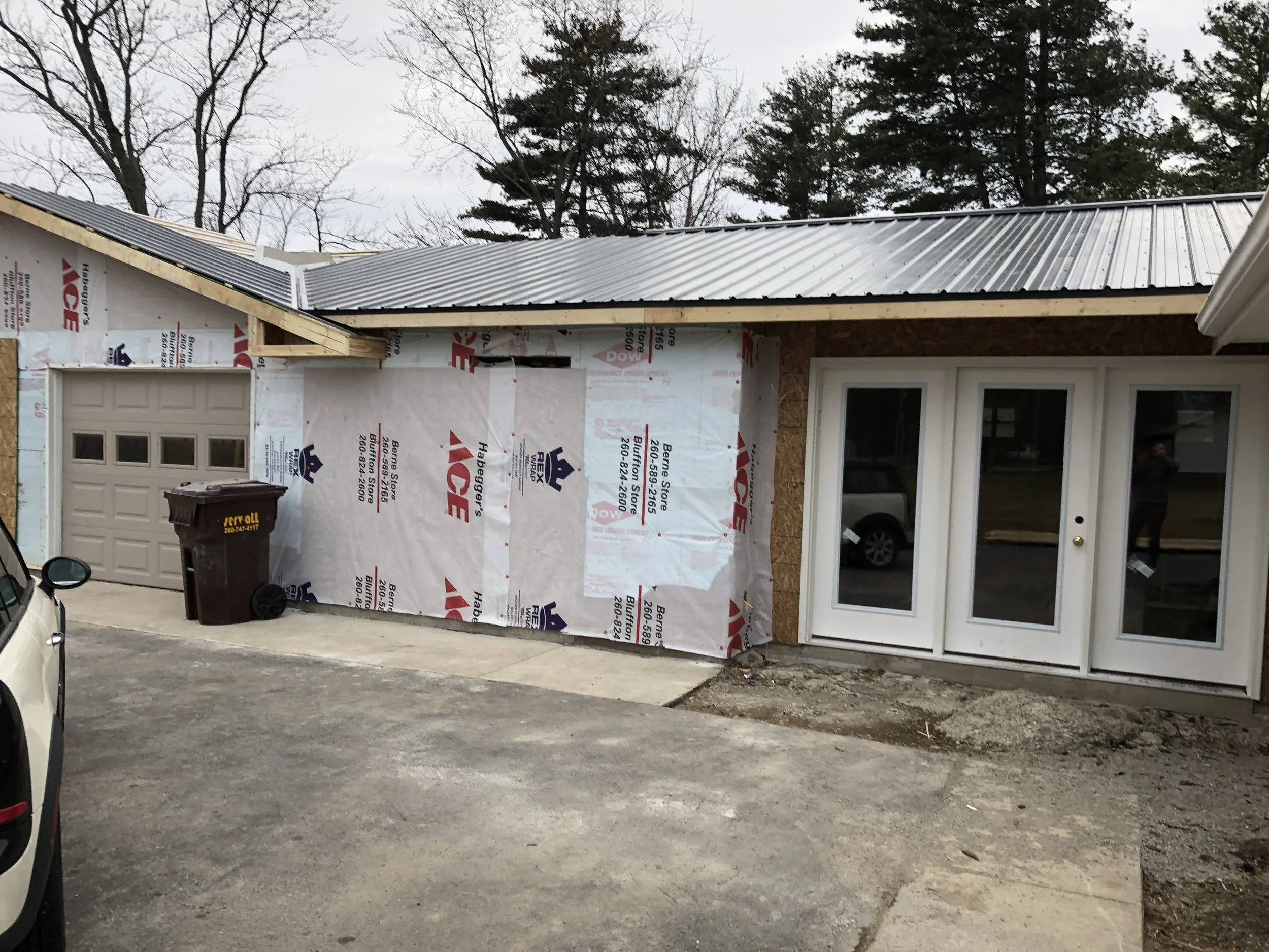 after: metal roof and peak over garage