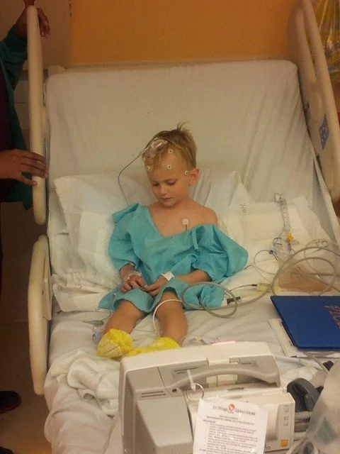 A child sitting in a hospital bed
