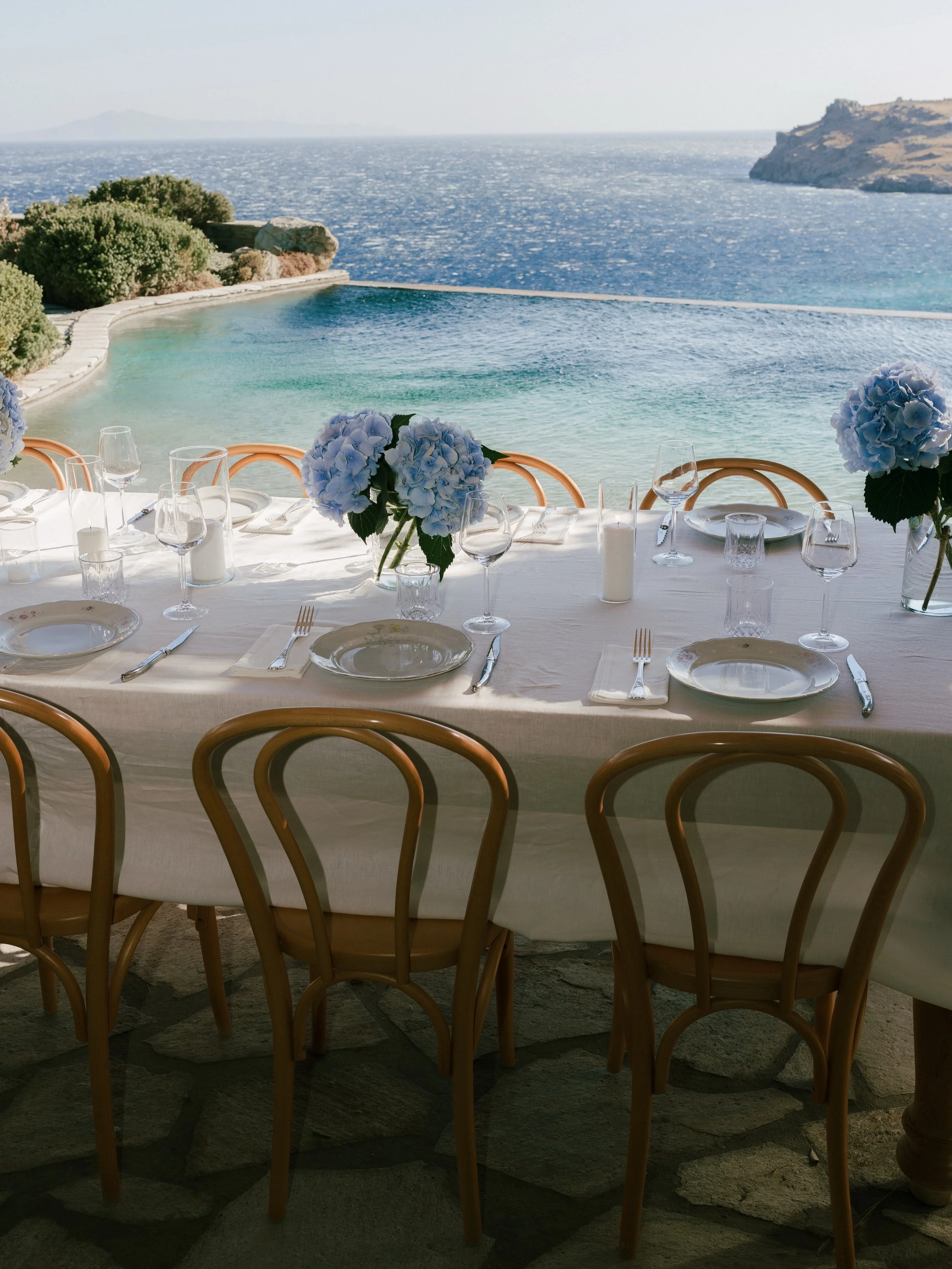 The M&egrave;lisses wedding recipe:

Give the celebration a whole weekend on Andros.
Invite your favourite 40-ish people.
Give everyone a front-row seat to the Aegean.
Dress the tables in white linen and flowers that make an impression.
Bring out the