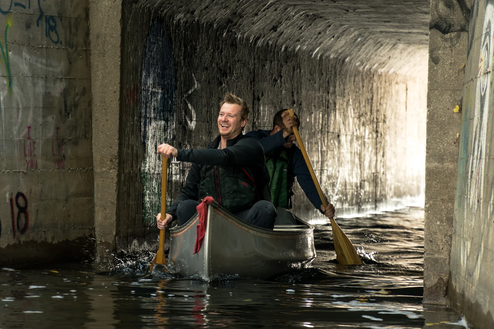A tandem canoe team exits the tunnel connecting Cedar Lake to Brownie Lake.