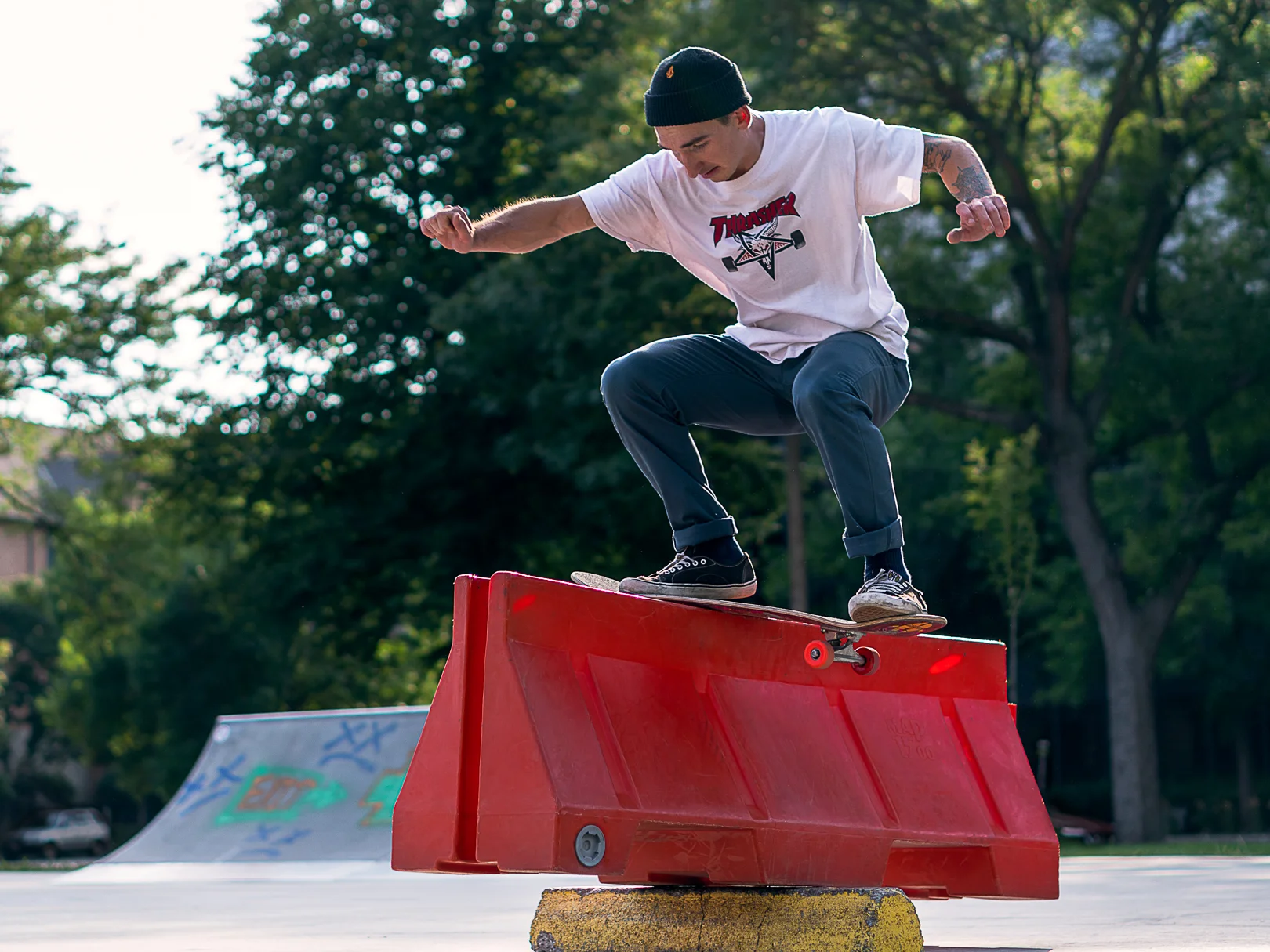 Andrew Helminiak backside boardslides up one side of a teeter-tottering barricade and back down the other at Elliot Park in Minneapolis, Minnesota.