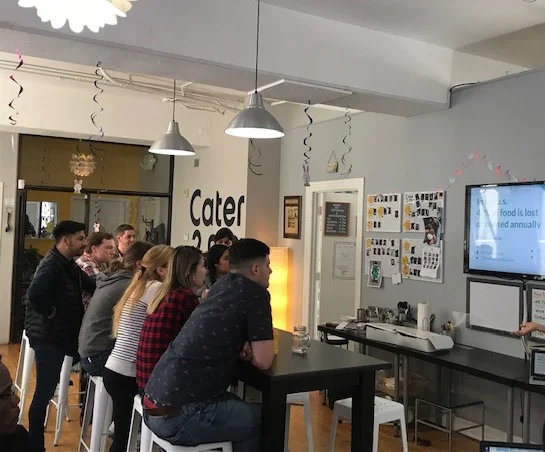 The Cater2Me SF team listening intently as our Community Manager, Jen, gives a lunch and learn on how and why of Replate.