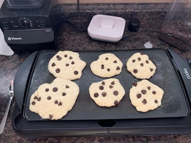 After you’ve let your batter rest, get that griddle out and get that batter on! We add chocolate chips to our pancakes. It started one year when my middle child wanted chocolate chips. We bargained and I told him I’d add them to pancakes. He won, I won. Win win! It’s since stuck and we put them in ever time. Also- we have yet to make a perfectly round pancake. I don’t think it runs in our blood.