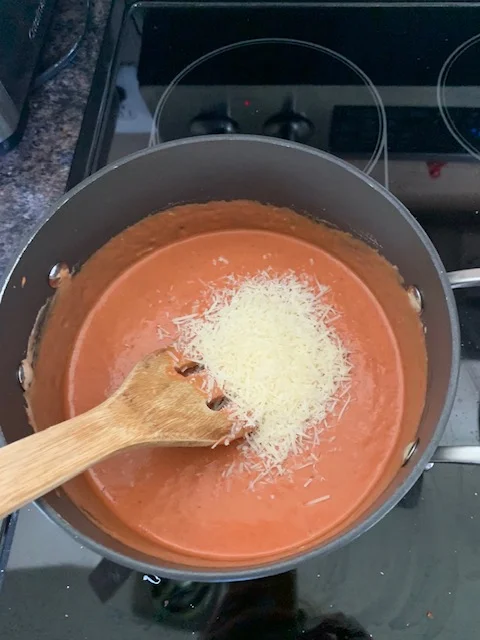 Add about 1/4 to 1/2 cup of parmesan cheese to your sauce and mix well. then let it sit till the pasta is cooked.