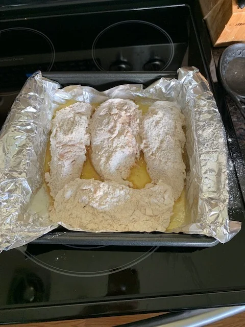 Place the chicken in the melted butter dish and USE OVEN MITTS! The dish will still be hot!!! (I learned the hard way) and place it in the oven for 35 minutes. If you’re using tenderloins, cook 25 min or until cooked through.