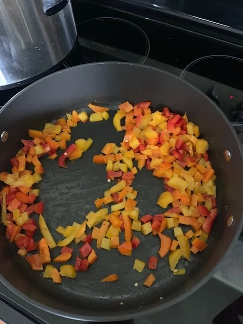 When chicken is done, cut up the peppers. You can cut them into strips, chunks, or small like this. My family prefers them cut like this. Sautee them and season them how you’d like over medium heat until soft but still has a crunch, 5-7 min. You can also add onions. My family won’t eat anything with onions in them so I leave them out.