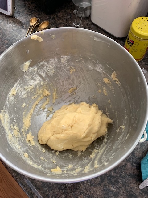 Beat butter and sugar/lemon mixture until light and fluffy. Beat in egg and vanilla and mix until smooth. Slowly beat in the flour mixture until blended. It’ll look the above picture.