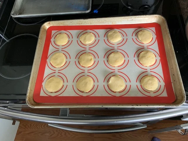 Drop dough by tbsp and flatten them out into little disks with your hands.
