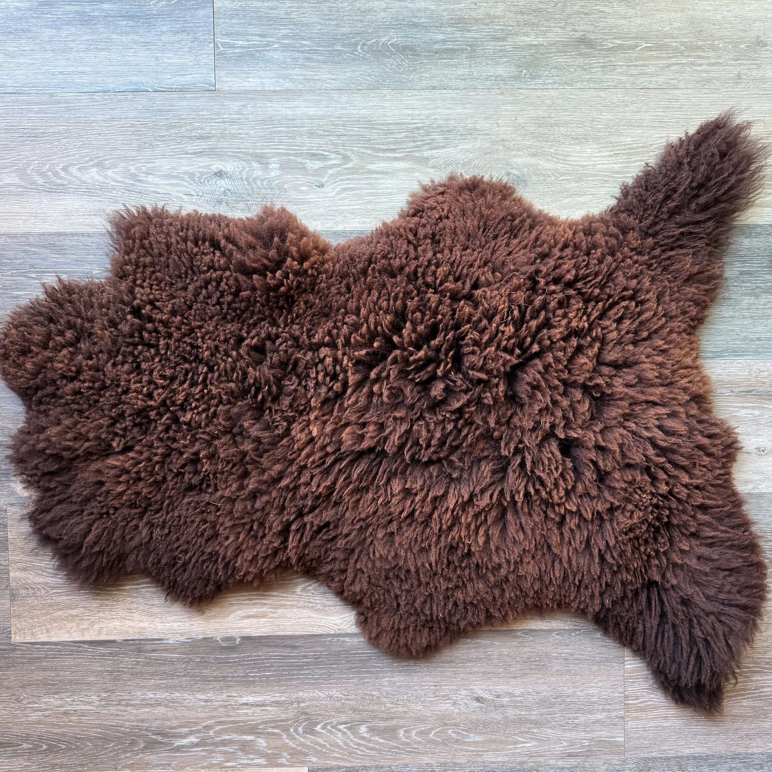Black lambskin on wood floor.