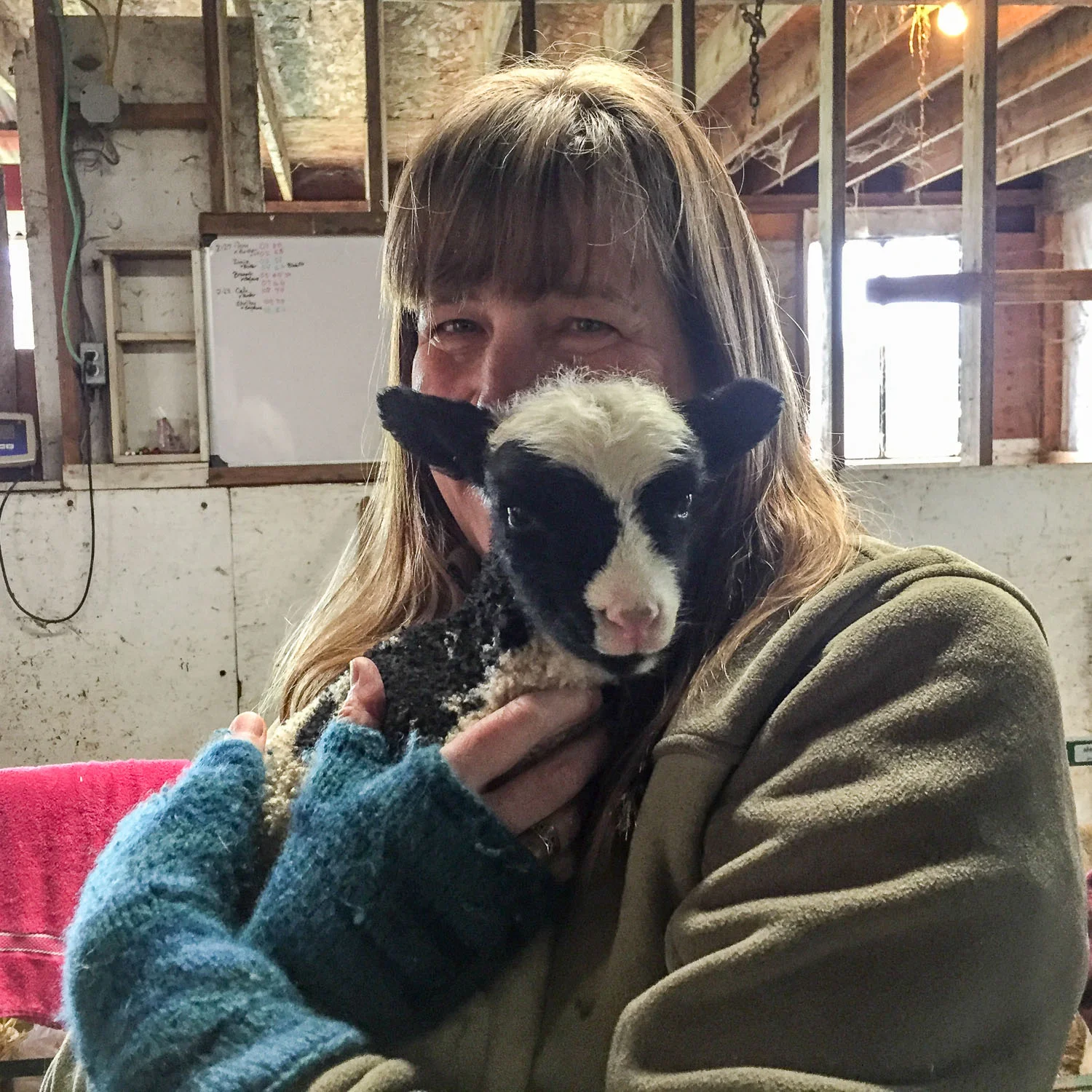 Lisa holding a lamb.