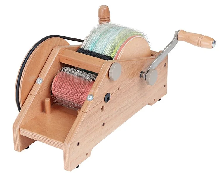 Narrow drum carder with green and white fiber.