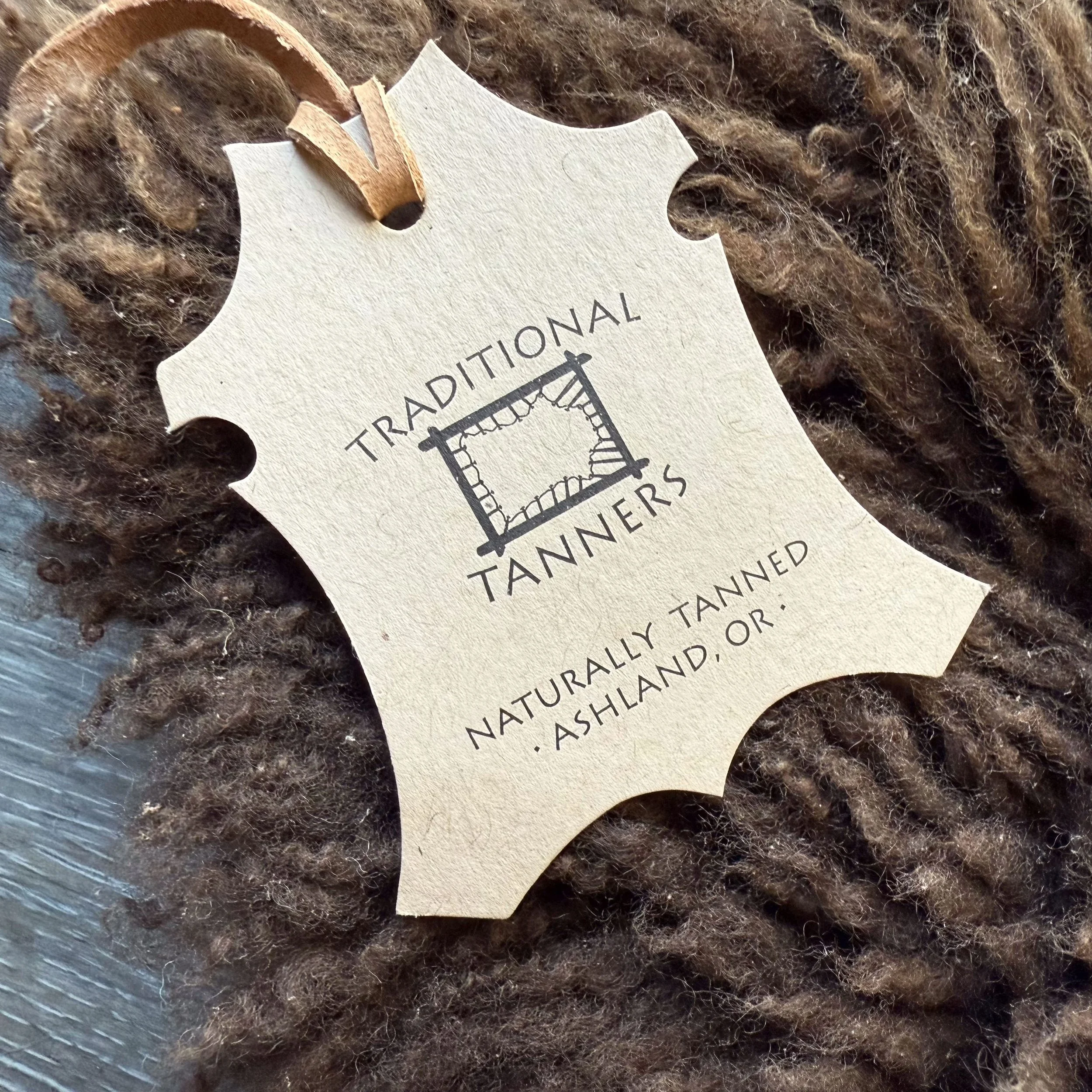 Tag showing tanner info on lambskin.