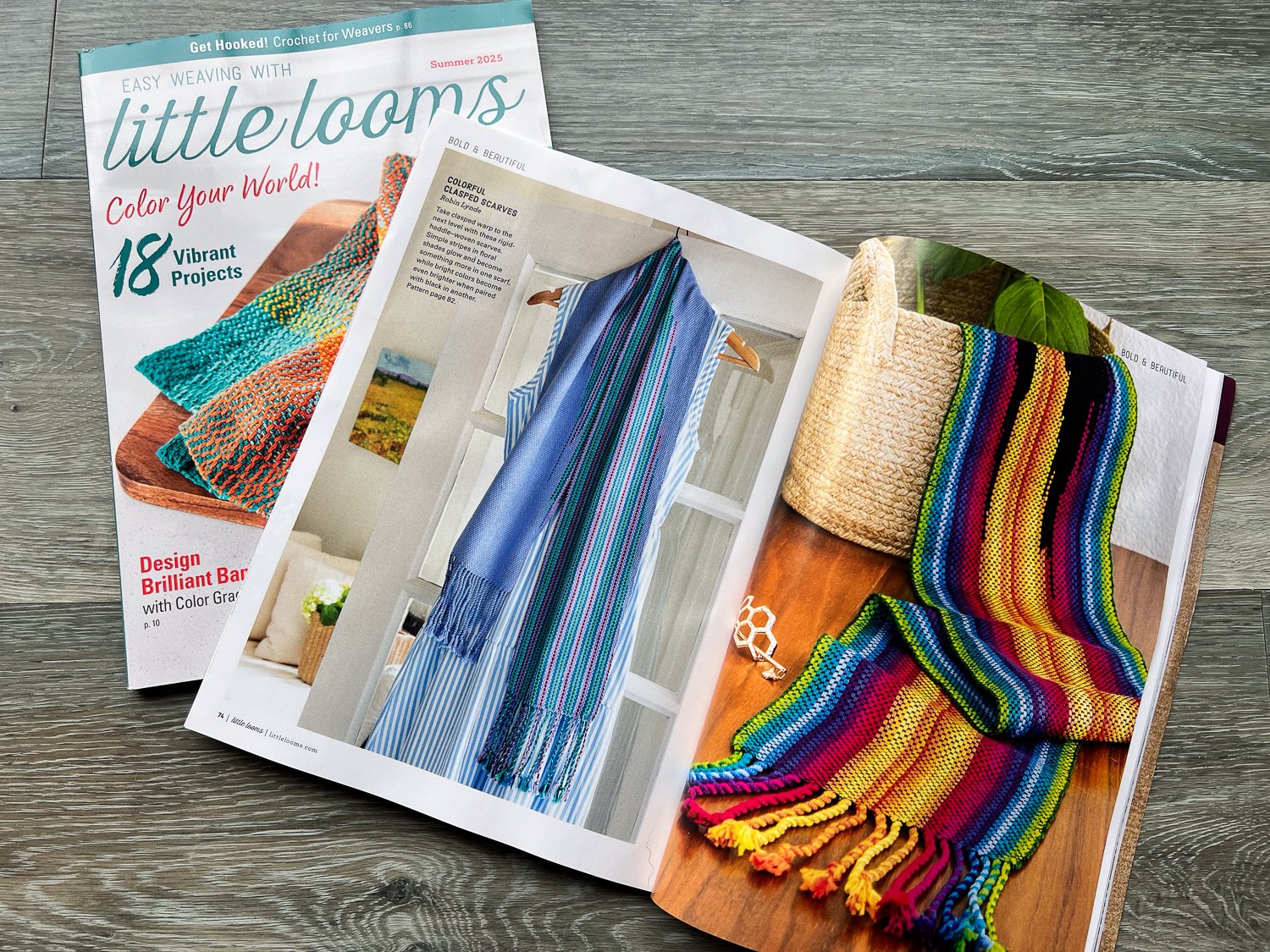 Magazine article with colorful clasped warp scarves.