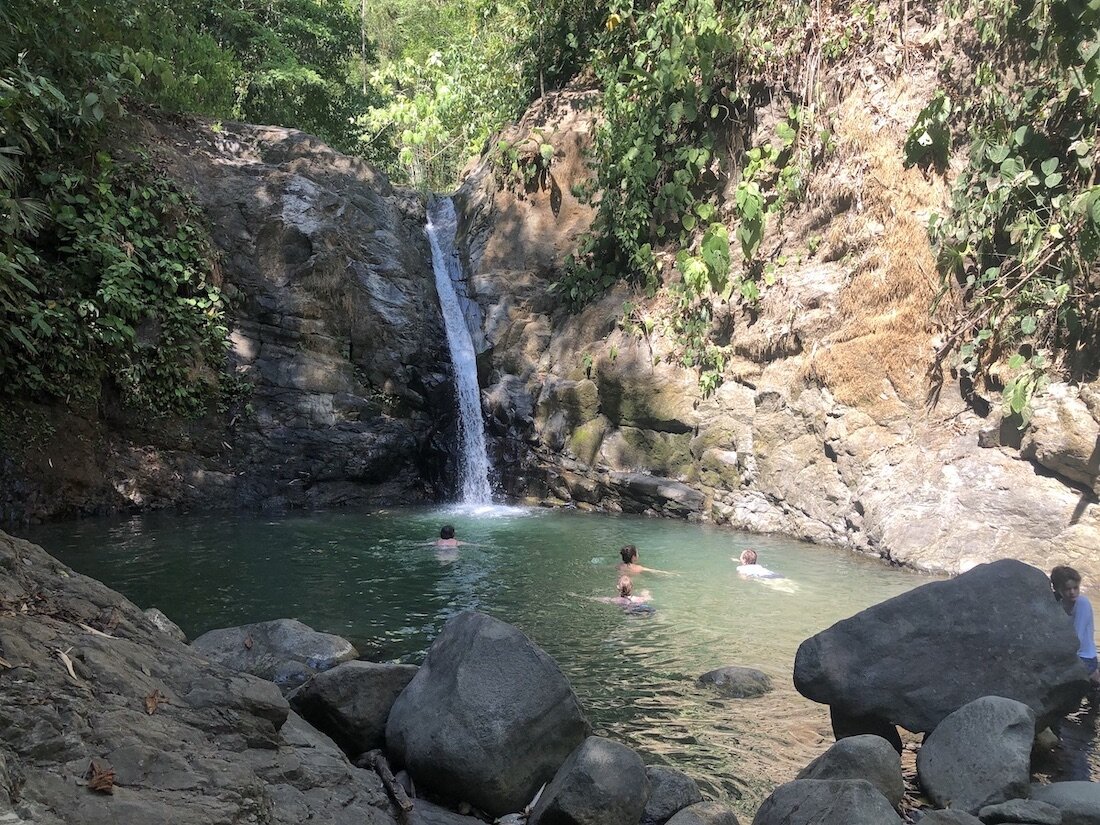 Swimming under Costa Rica waterfall