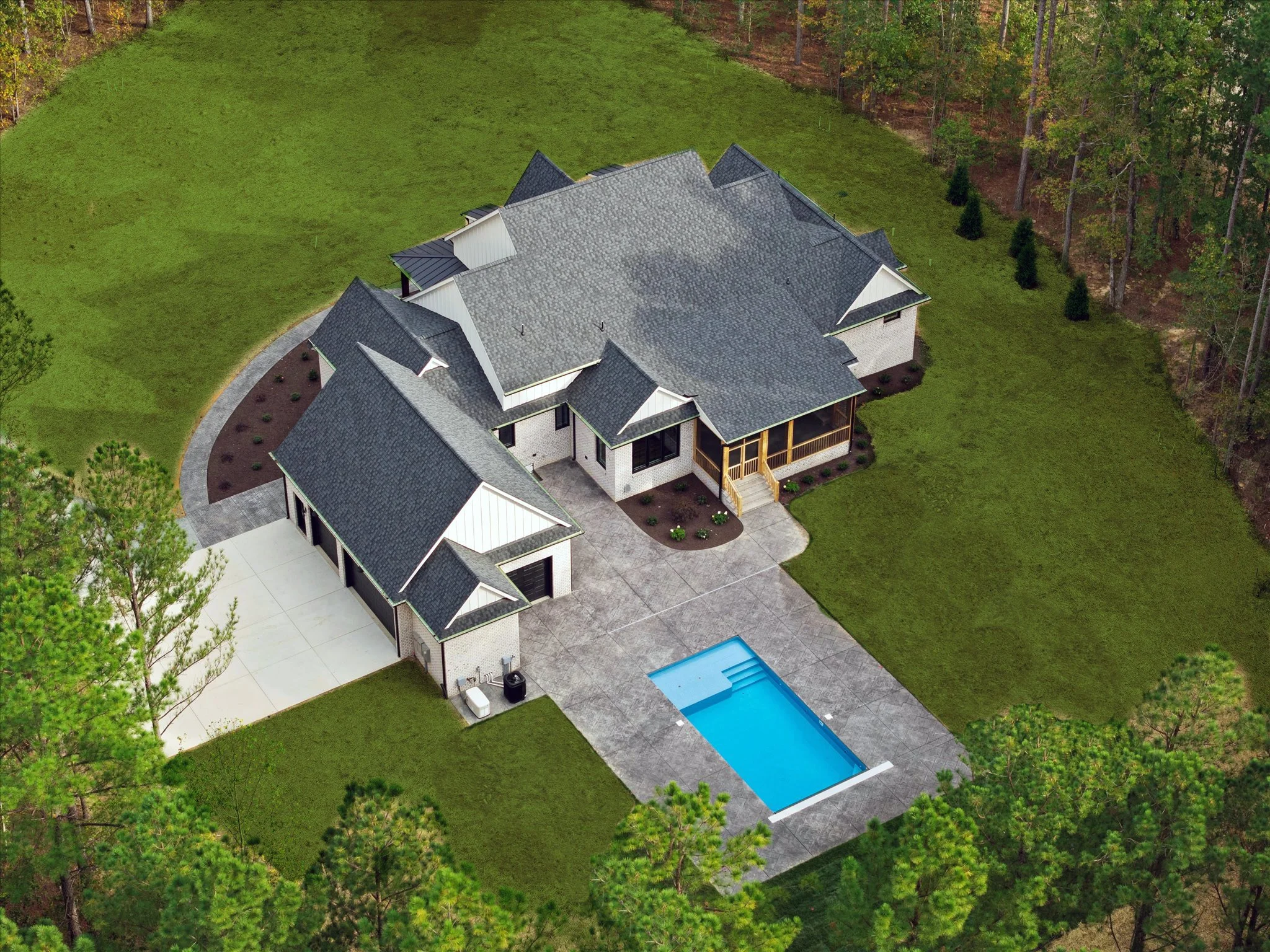 Aerial view of a modern house with a gray roof, white exterior, a screened porch, and a rectangular swimming pool in the backyard, surrounded by a well-maintained lawn and trees.
