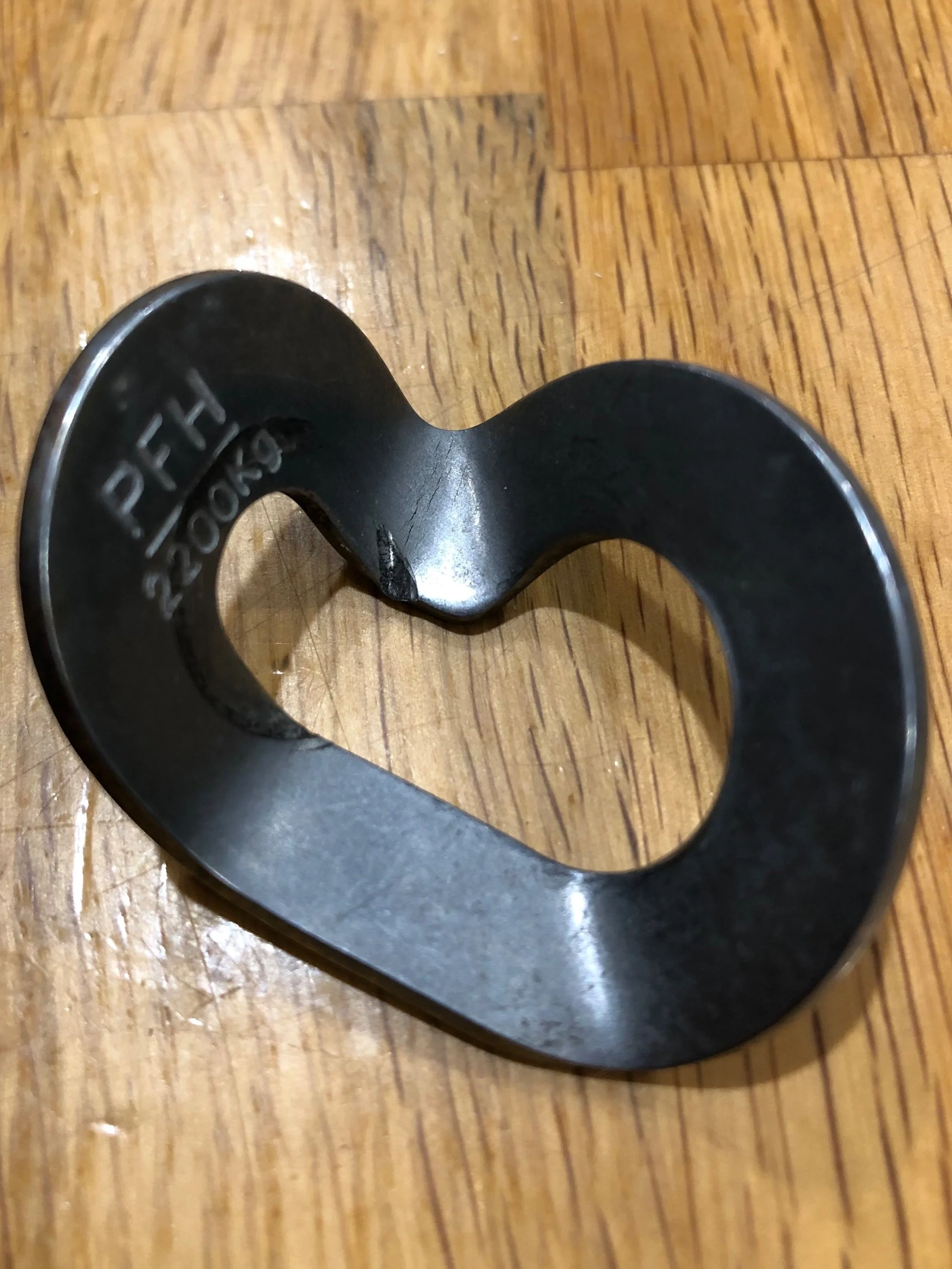 There is a serious gouge from the head of the bolt digging into the hanger. Also you can see several hairline fractures next to the gouge.