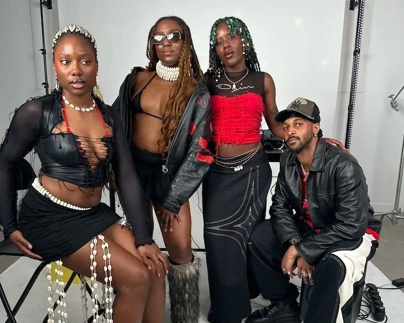 Collectif Echoes crew photoshoot, in order of appearance: Angelica, Michelle, Maz and Samatar. Members all wear fashionable clubbing clothes with a colour scheme of greens, reds, and blacks.