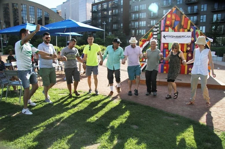Men and women dancing at potluck