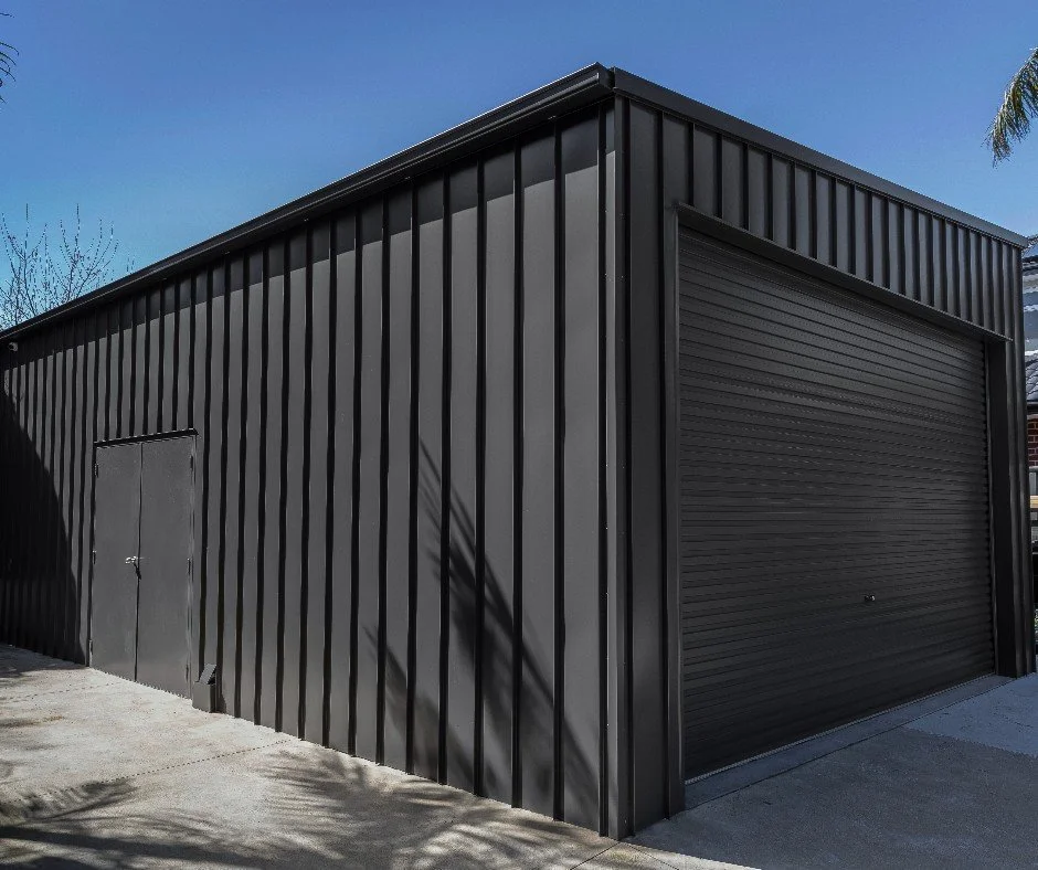 Black skillion roof shed with roller door
