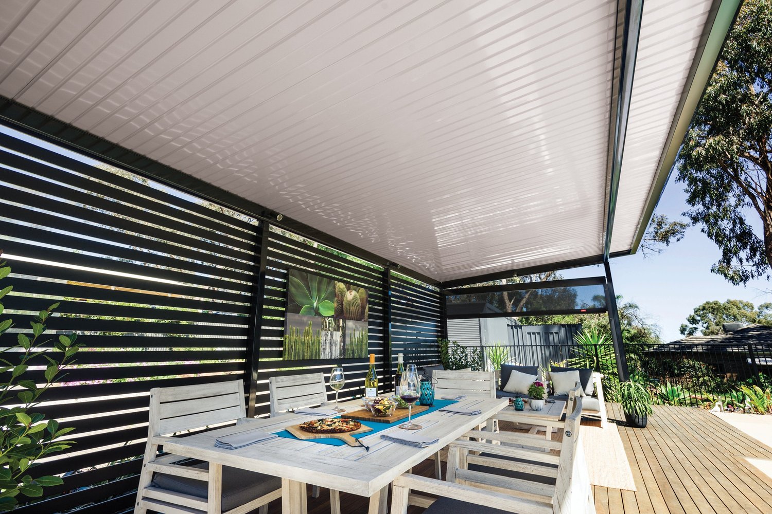 White flat roof patio over an outdoor dining setting