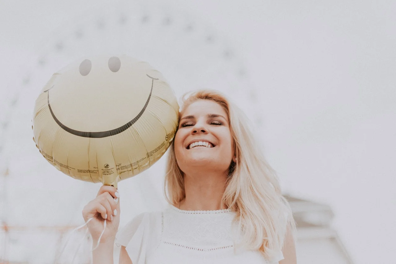 people pleaser woman with yellow balloon.jpeg