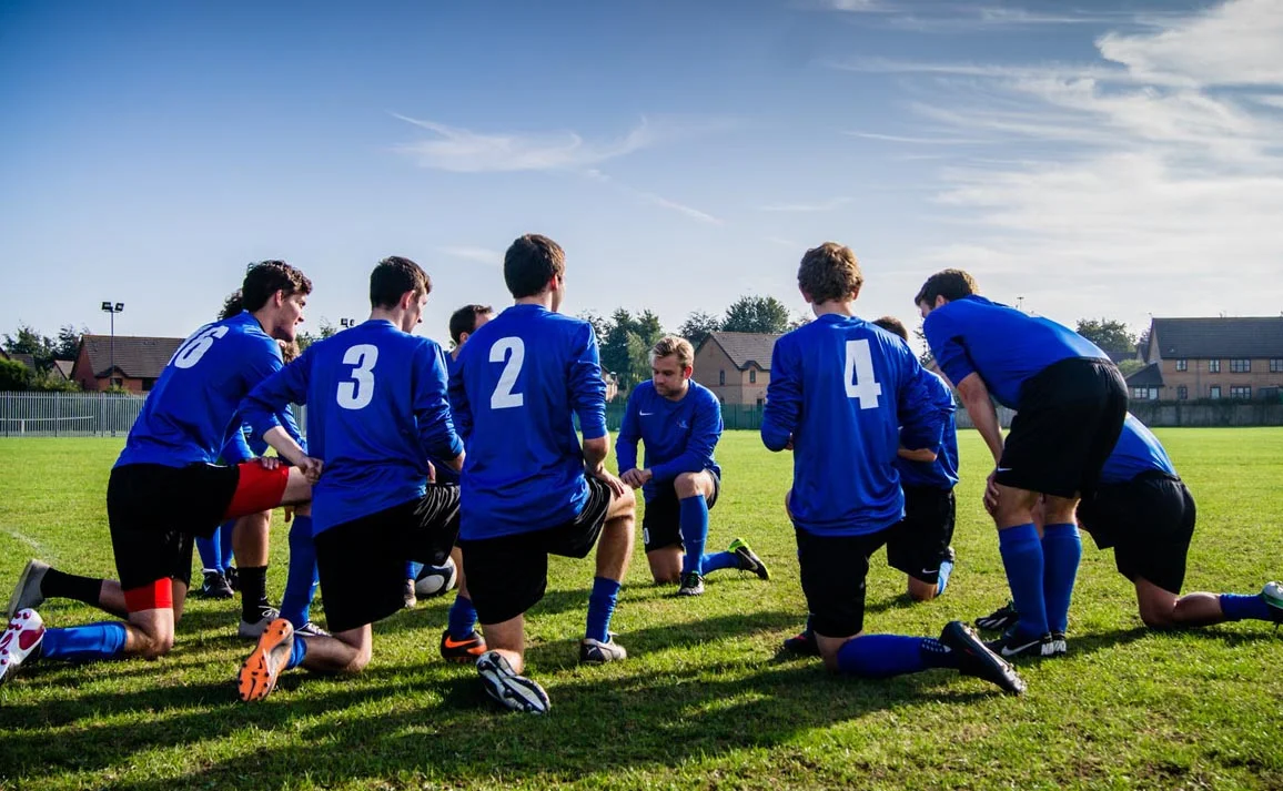 sports team huddling kneeling.jpg