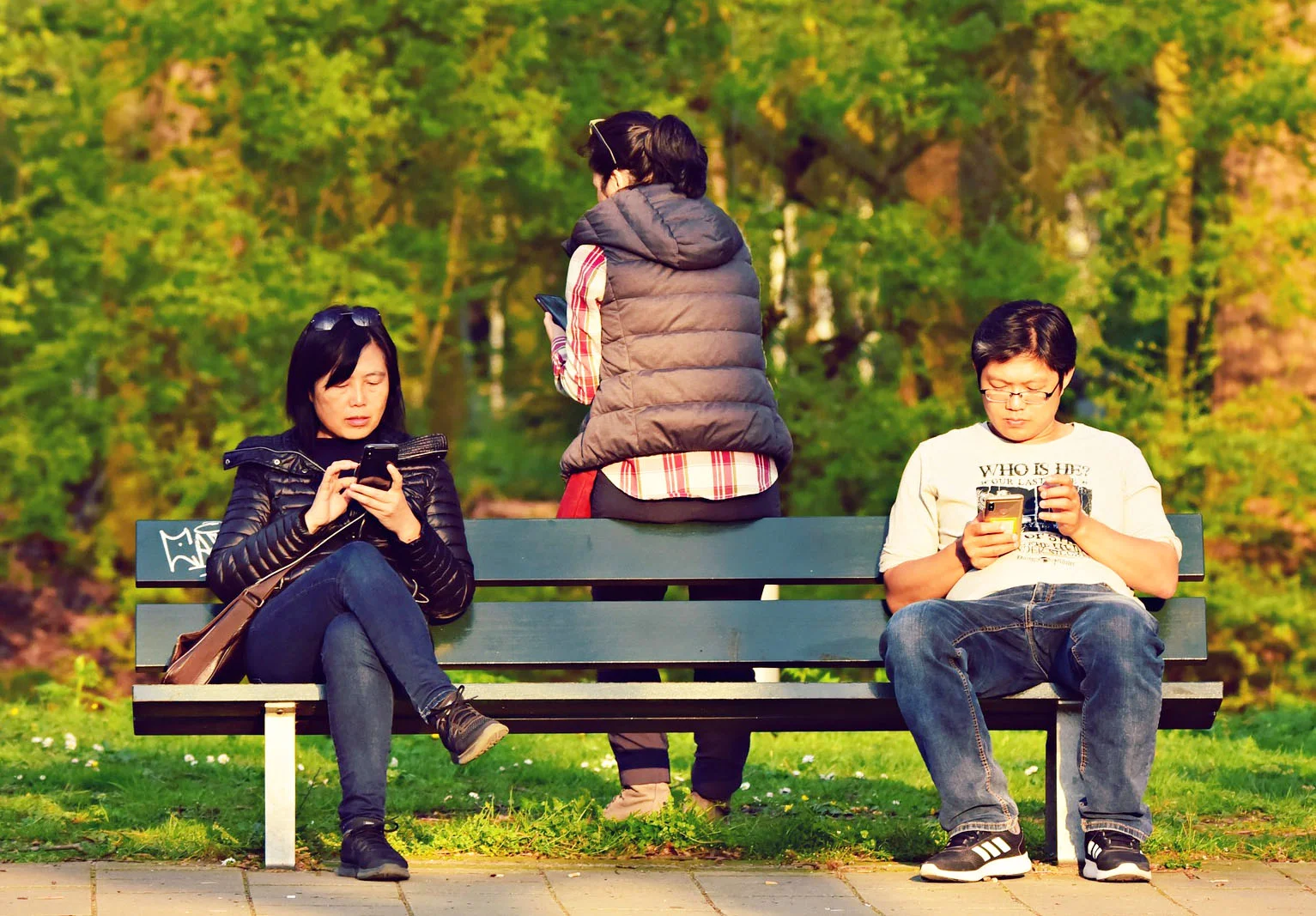 people using smartphone on bench.jpg